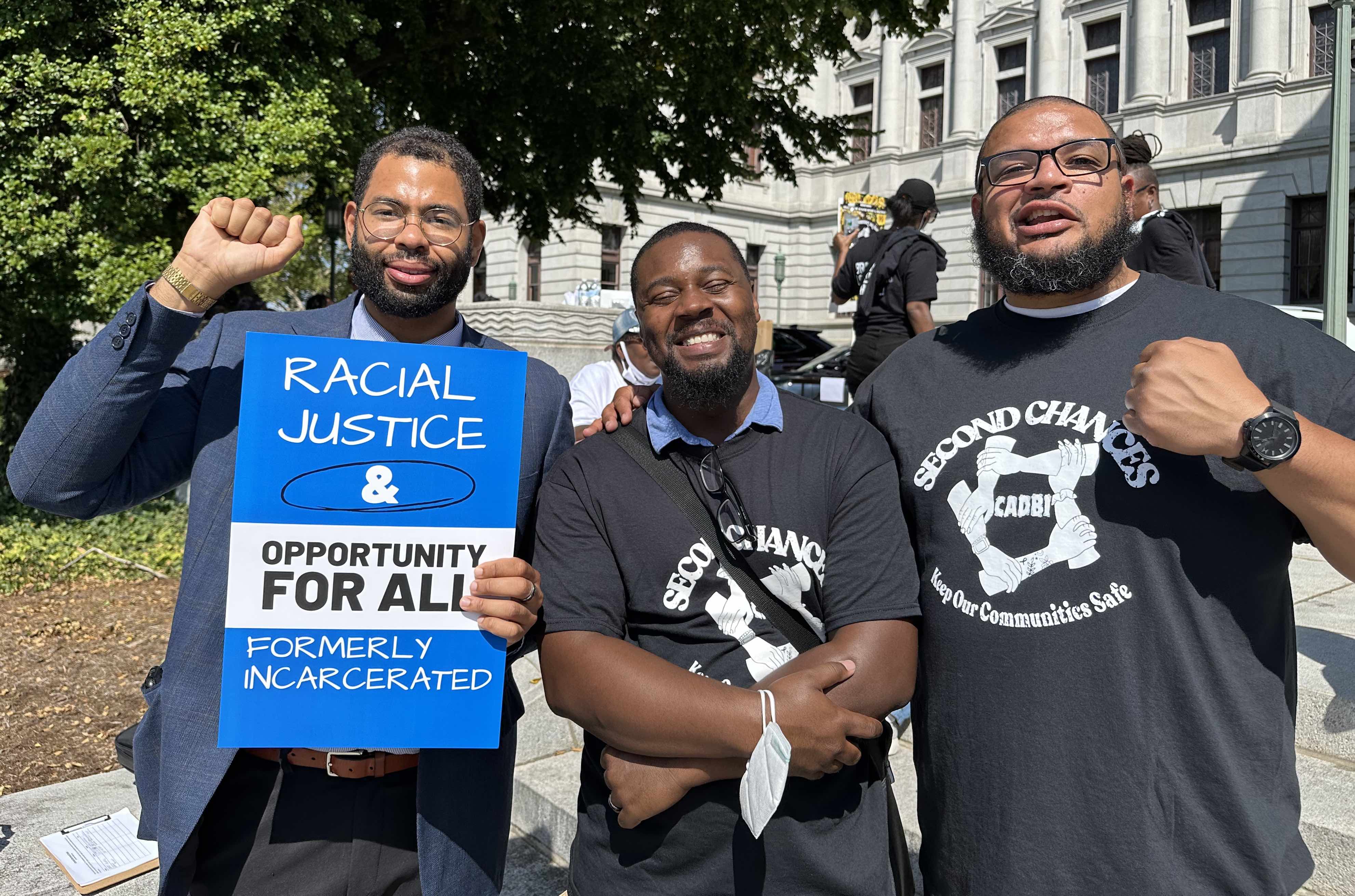 Derrick Stephens, State Rep Rick Krajewksi and Sergio Hyland stand together