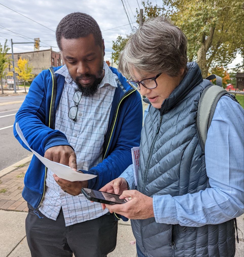 Amistad Movement Power Lead Field Organizer Derrick Stephens instructs on volunteer on where they will be canvassing