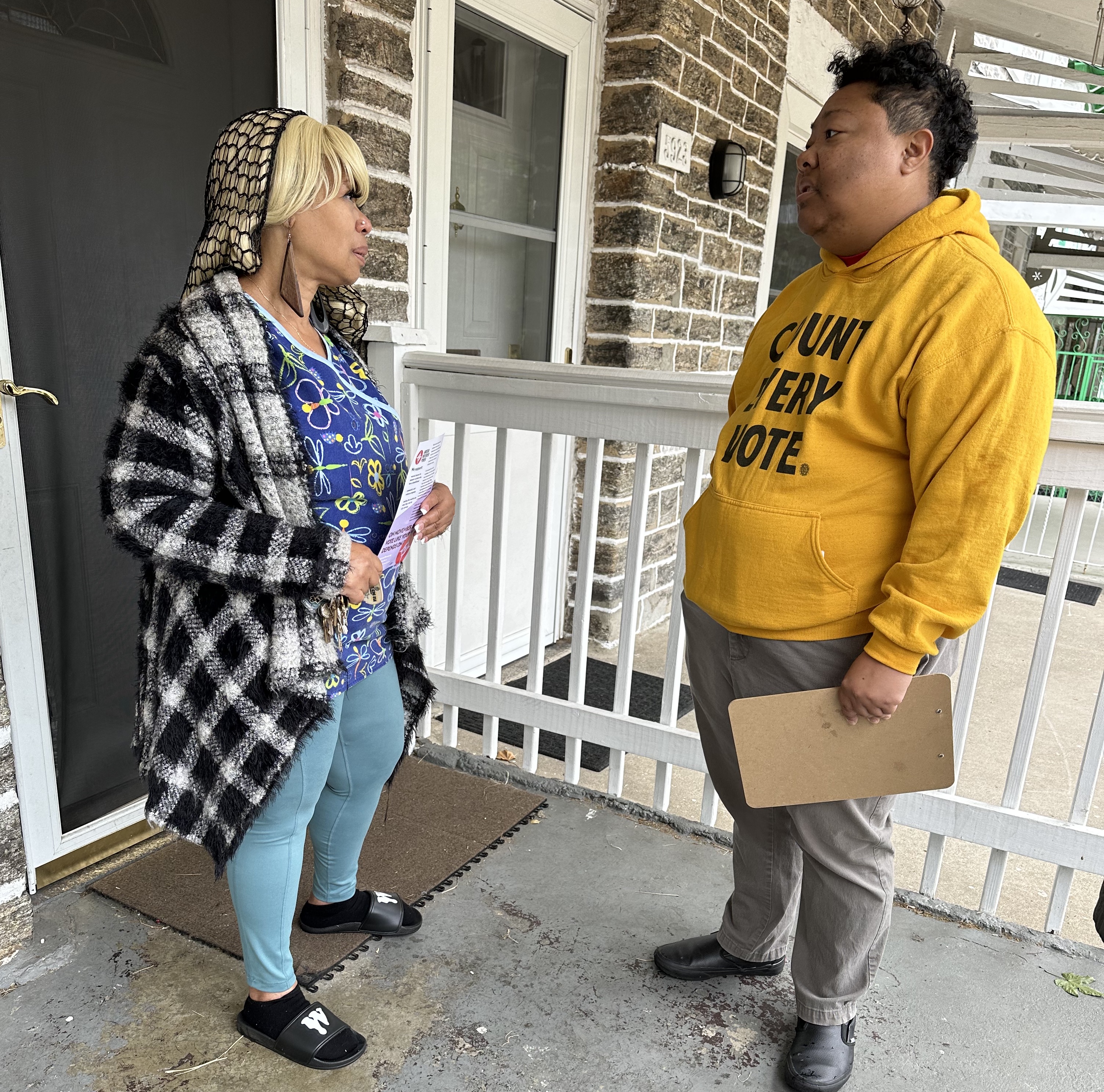 Amistad Movement Power Executive Director Kris Henderson has a discussion with a neighbor in Germantown about the November 8th election