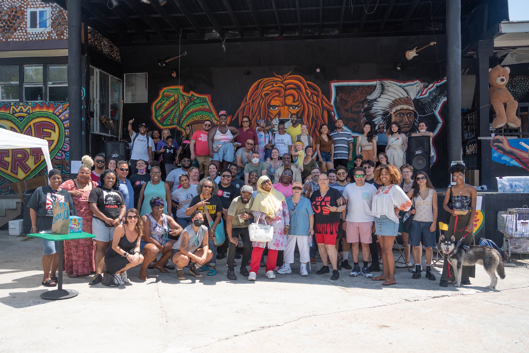 a crowd gathers near the stage for a group photo