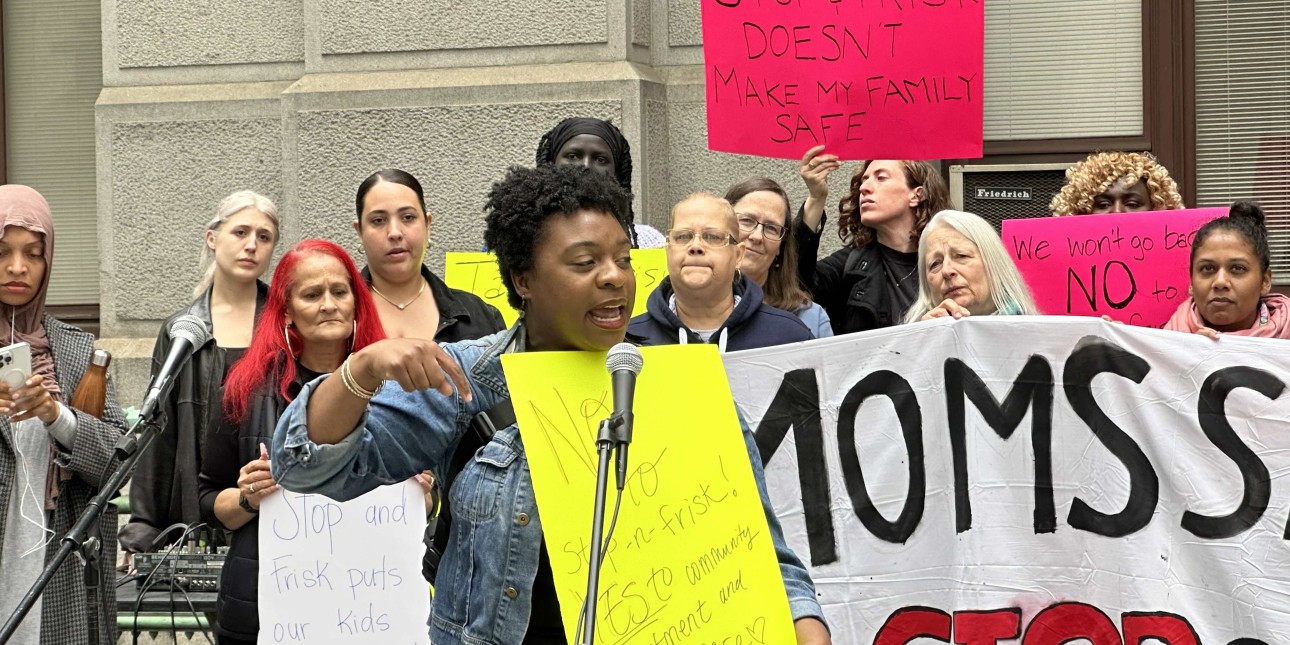 Chantelle Todman speaks in front of a banner that reads Moms Say No to Stop and Frisk