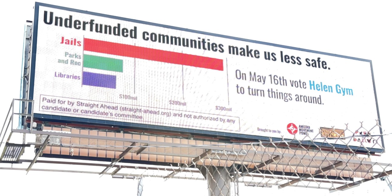 A billboard says 'Underfunded Communities Make Us Less Safe. On May 16 vote Helen Gym to turn things around.'