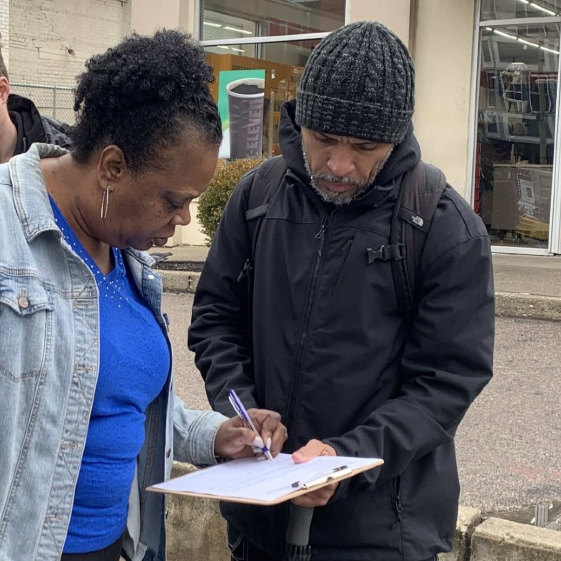 ghani and jay canvass talk to two people while canvassing