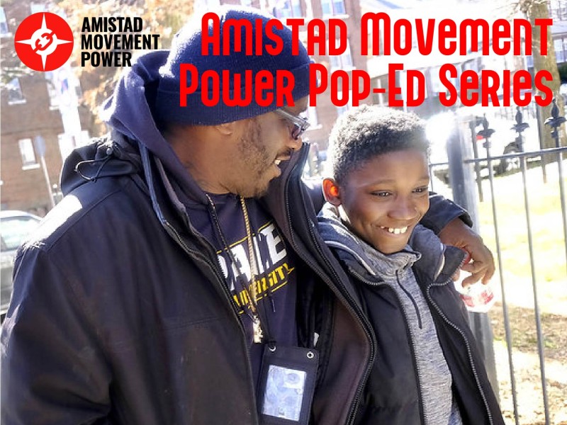a man walks with arm around a boy and heading reads Amistad Movement Power Pop-Ed Series
